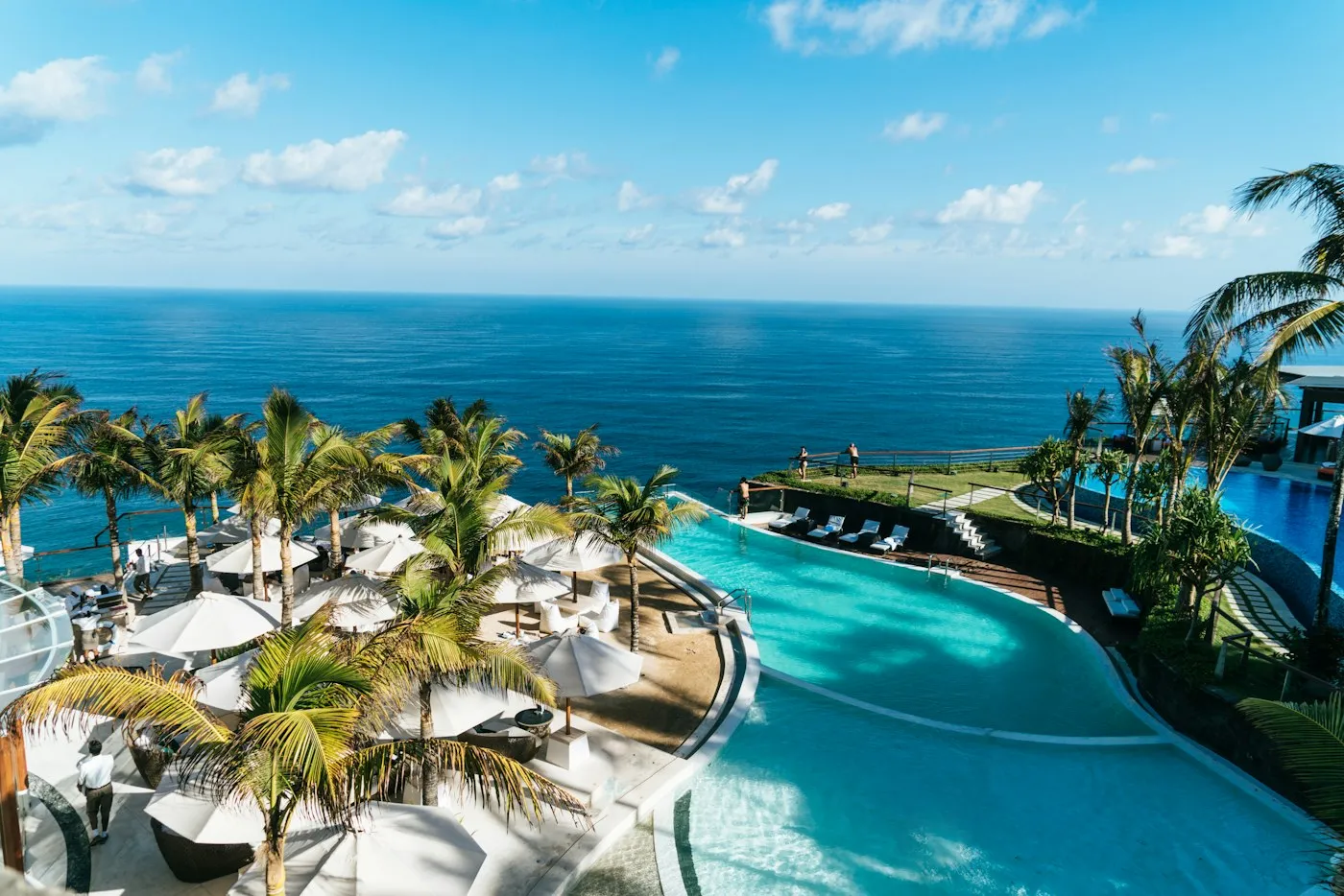 A calm luxury resort pool beside the sea